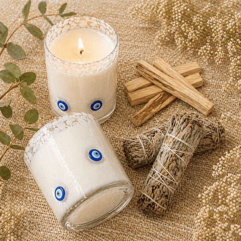 Protection pack with evil eye candle, smudge stick and palo santo for energy cleansing and protection rituals.